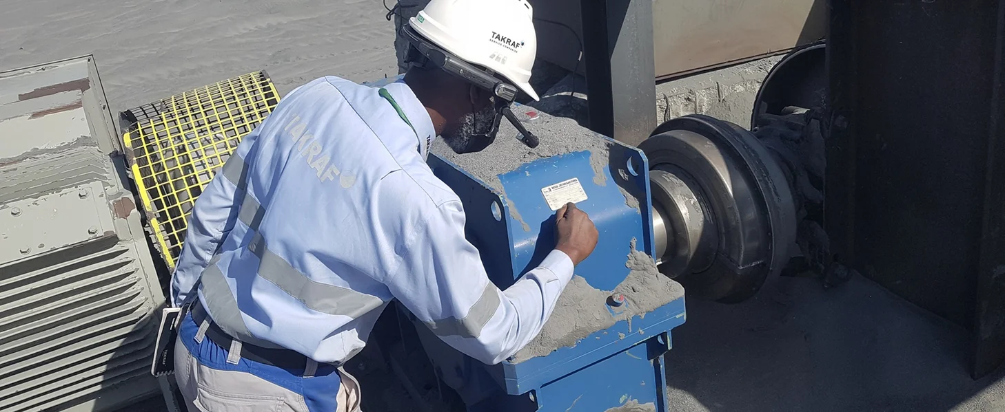 A man checking out the details on a sign at a conveyor in Mauretania.