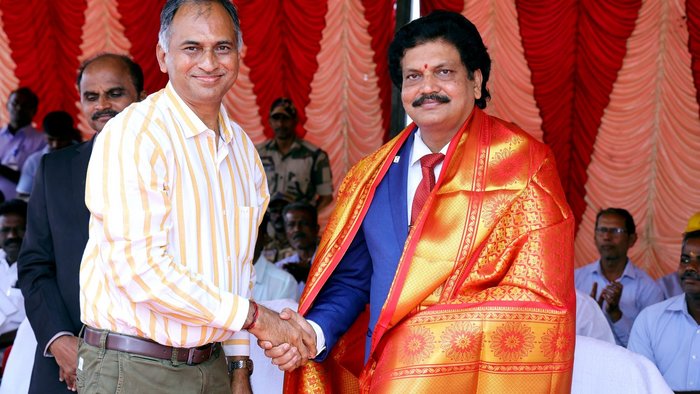 Two men congratulate each other and shake hands.