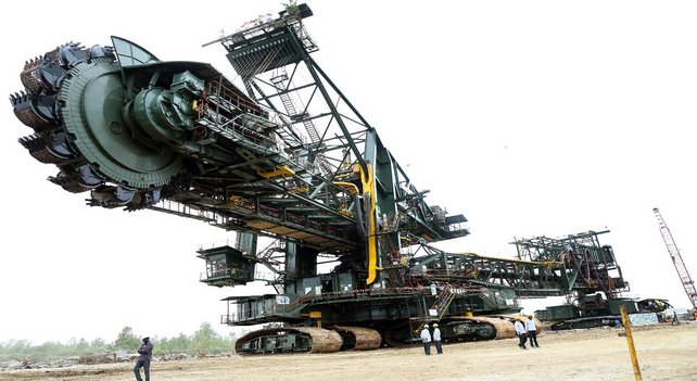 A huge TAKRAF bucket wheel excavator, which has been overhauled, stands in an open field in India.