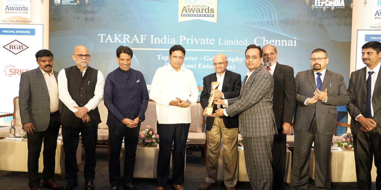 A group of award recipients on stage at the EEPC India Southern Region Export Excellence Awards ceremony, with a government representative presenting a trophy to a TAKRAF India representative in Hyderabad.