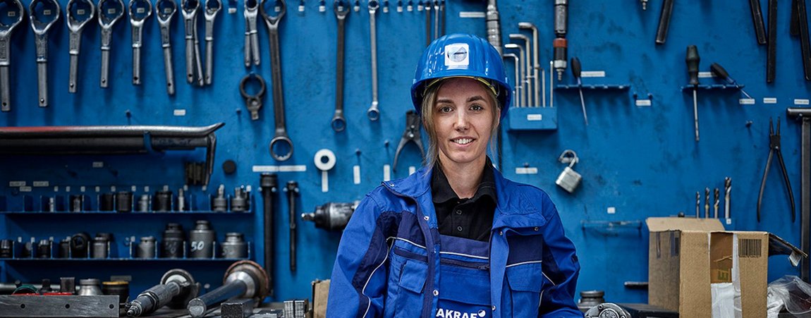 The picture shows a woman working in production at TAKRAF.