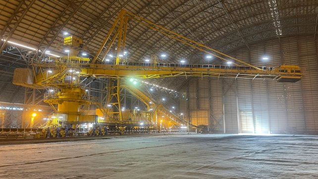 A yellow TAKRAF Stacker standing in a hall