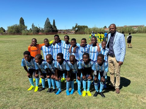 The picture shows a group of happy students  wearing the new soccer kits.