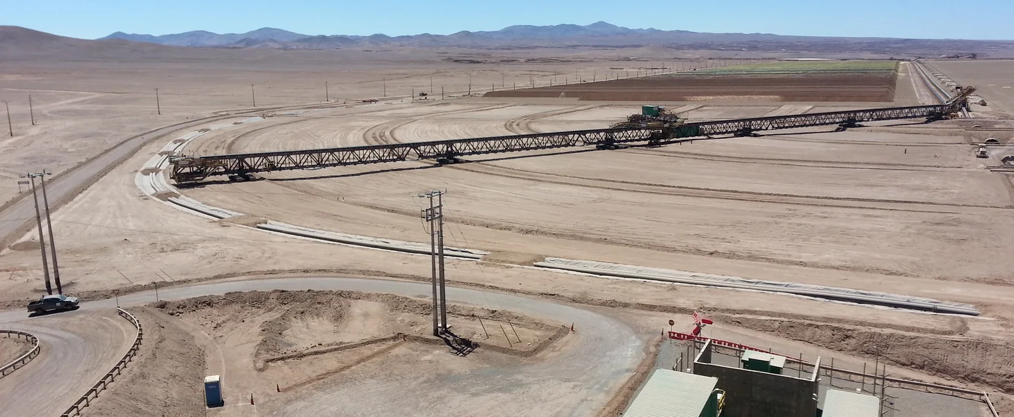 TAKRAF mobile stacking bridge turning on a heap leach pad in Chile