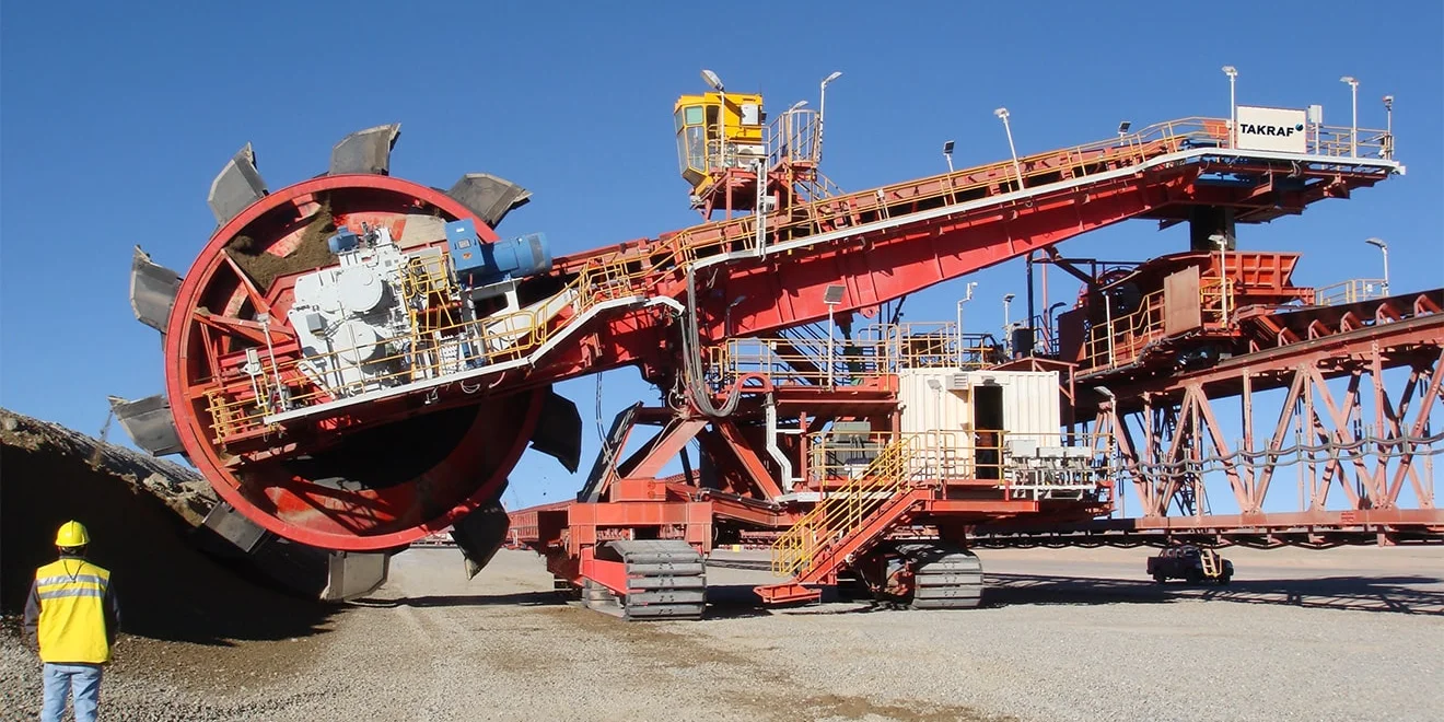 TAKRAF Mobile Reclaiming Bridge and TAKRAF Reclaimer at a leach pad operation.