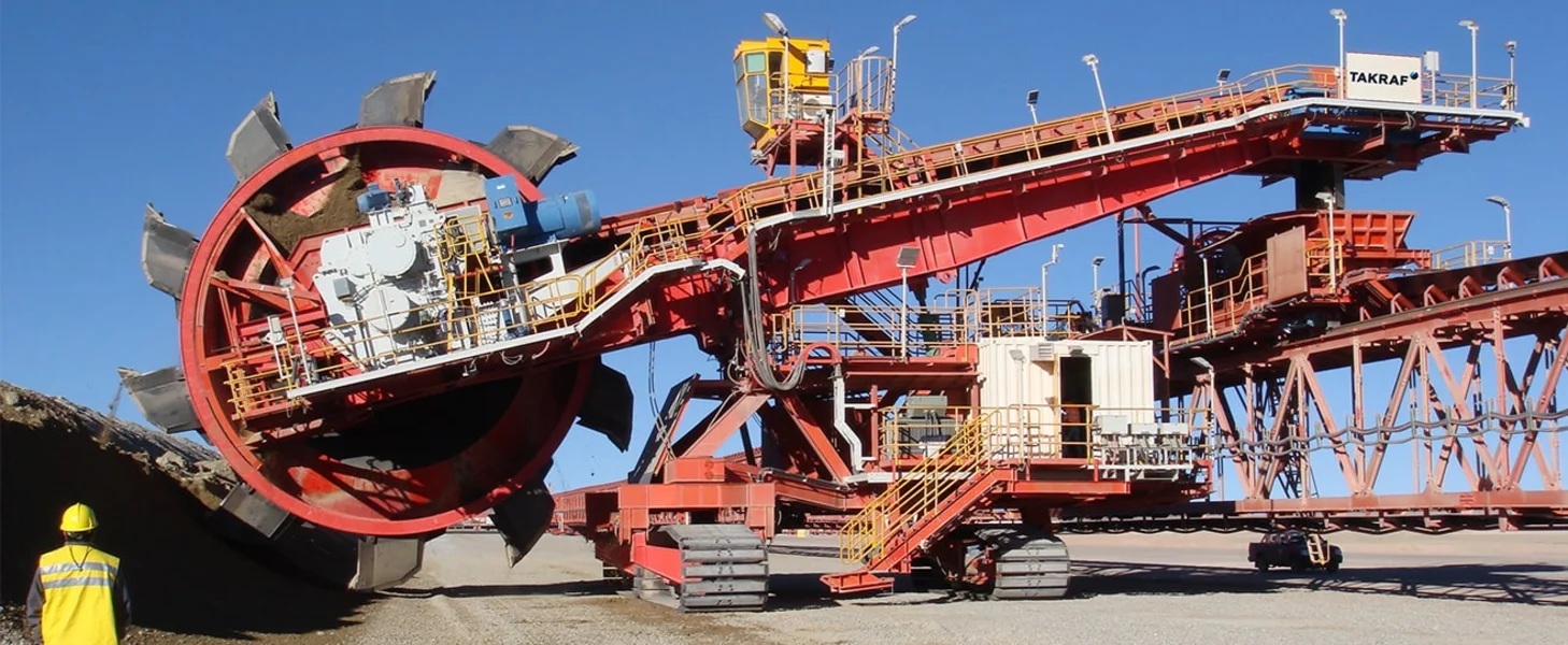 TAKRAF Mobile Reclaiming Bridge and TAKRAF Reclaimer at a leach pad operation.