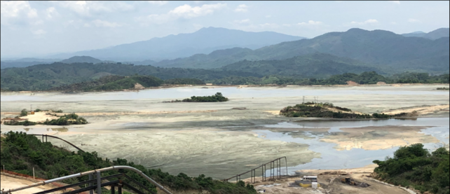 The picture shows an elevated view of the paste tailings pond.