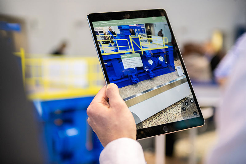 Someone taking a picture of a TAKRAF machine with a tablet